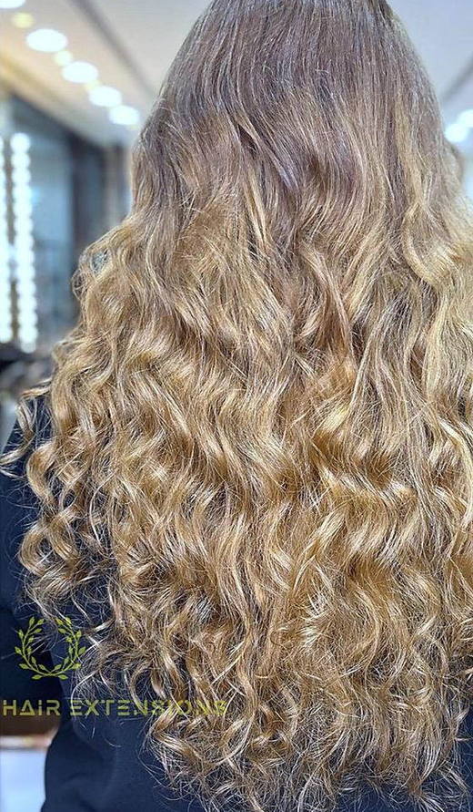 Blonde curls after extensions at PhiStudio Dubai
