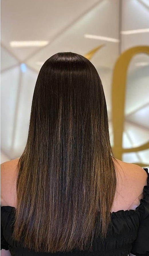 Warm brown waves before extensions at PhiStudio Dubai